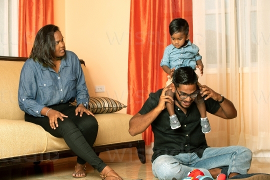 Family in on Sofa in Living Room VIII