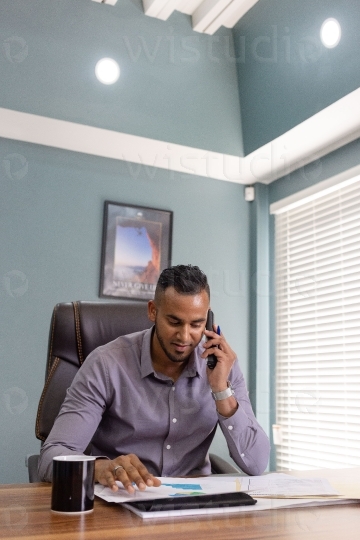 Male Employee in office chatting on phone