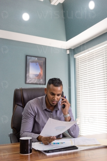 Male Employee in office on a call