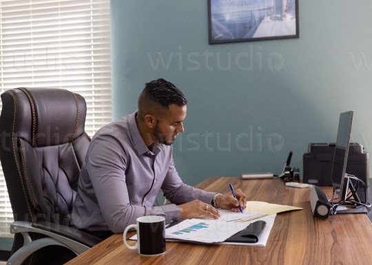 Male Employee in office taking notes