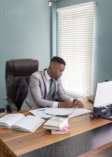 Male in office taking notes