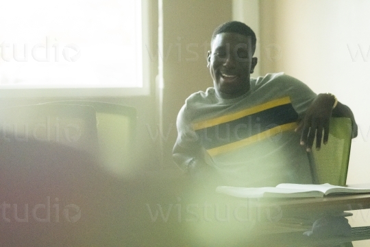 Male student relaxing in Class