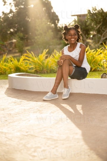 Smiling Girl Sitting Outside