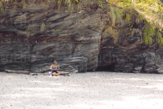 Woman Meditating on Beach